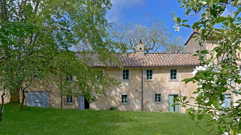 Casa di Giulio's front facade with blue grey windows and doors